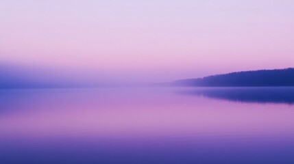 Fototapeta premium Serene foggy lake surrounded by trees at dawn