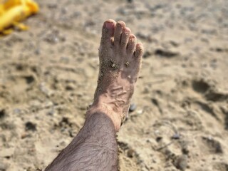 Sandy Male Foot on a Summer Beach