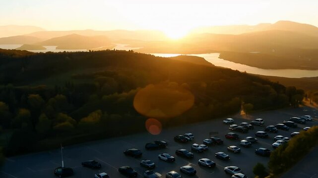 Sweeping drone footage reveals rolling landscapes bathed golden hour light blending urban details natural vistas sun paints warm hues over mountaintops valleys creating cinematic breathtaking 4K