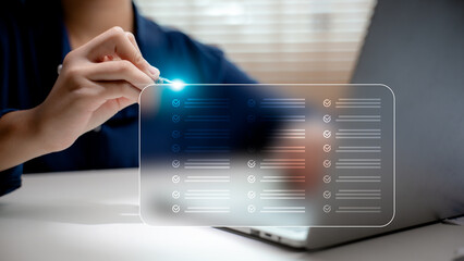 Digital checklist concept with hand-held stylus and checking tasks on a virtual screen. Business productivity planning, task management, and organization strategy concept.
