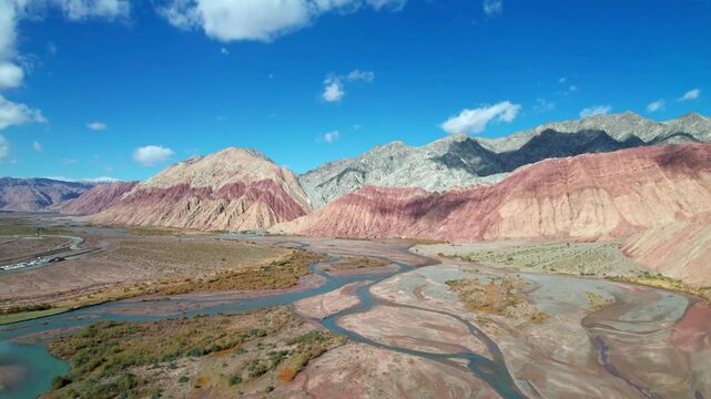 Drone view of Yadan landform near Kashgar in southern Xinjiang, China. High angle view of colorful mountains in sunny autumn day, 4k real time landscape footage b roll shot.