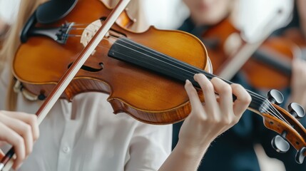 Close-up of a Violinist's Hand Holding a Bow While Playing Beautiful Classical Music in an Orchestra Setting