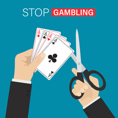 Stop gambling addiction. Human hands uses scissors and cutting a playing cards. Online casino ban, stop gambling, prohibition. Restrictions for offline gambling.