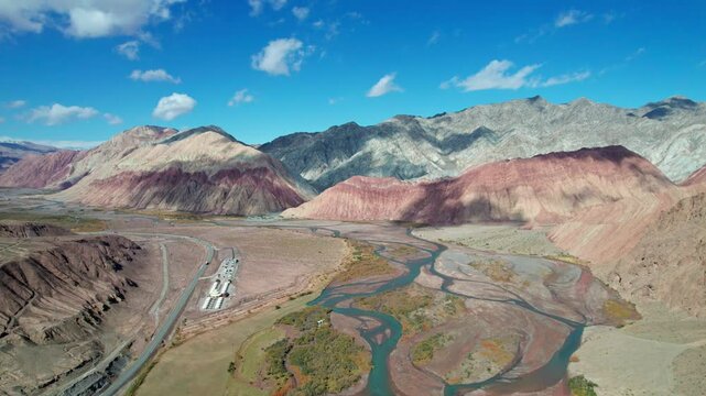 Drone view of Yadan landform near Kashgar in southern Xinjiang, China. High angle view of colorful mountains in sunny autumn day, 4k hyper time lapse landscape footage b roll shot.