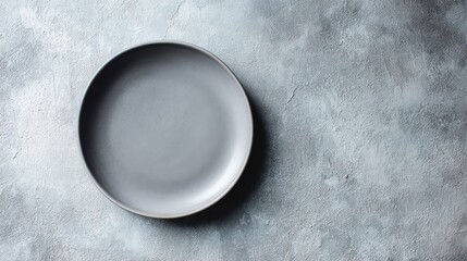 Empty gray ceramic plate on a textured gray background perfect for food  or restaurant menu design