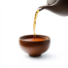Warm tea being poured from a teapot into a small wooden bowl on a white background for hot beverages and traditional serving