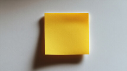 Blank yellow sticky note on white surface
