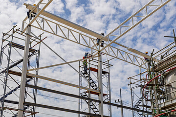 Naklejka premium Architect on site construction roof workers on a scaffold