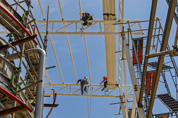 Architect on site construction roof workers on a scaffold