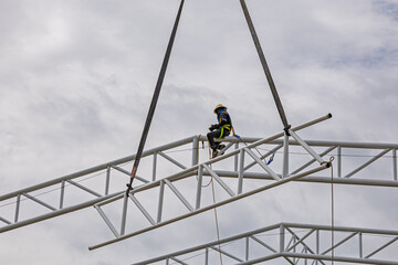 Architect on site construction roof workers on a scaffold