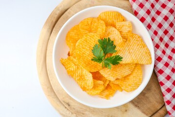 Potato chips in white plate on white  background