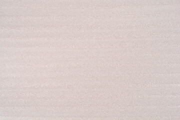 Fototapeta premium A close-up of the texture of a light grey EPE foam sheet with horizontal striations