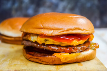 close up of cheeseburger on wooden table