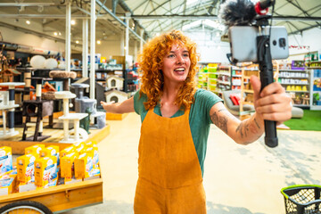 Pet shop worker filming a video for social media marketing