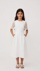Full length of confident Spanish girl in a formal white dress with lace sleeves standing with both hands at sides and smiling brightly on plain white background