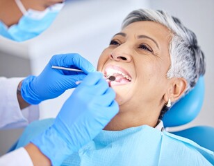 Professional Dentist Performing Routine Oral Examination on Elderly Female in Modern Clinic