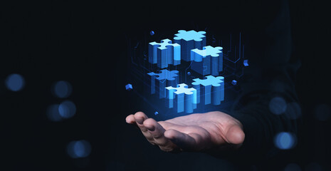 Digital puzzle blocks floating above hand on dark background conceptually arranged.