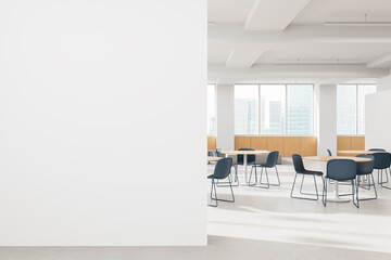 Modern minimalist office cafeteria interior with round tables and blue chairs in a bright open space with large windows and cityscape view. 3D Rendering