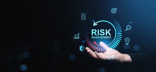 Risk management concept with digital icons above a hand, symbolizing protection, investment, and business strategy on dark blue background.