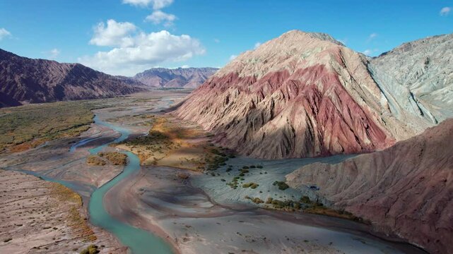 Drone view of Yadan landform near Kashgar in southern Xinjiang, China. High angle view of colorful mountains in sunny autumn day, 4k real time landscape footage b roll shot.