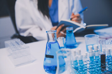 Research, experiment and medical trial being done by a scientist in a lab, science facility or hospital. One young, serious and professional researcher organizing, sorting or making a discovery