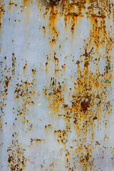 Rusted metal surface with peeling paint in urban setting