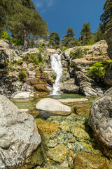 Water cascades over the Cascade des Anglais on the L'Agnone river through the forest and mountains of the GR20 trail at Vizzavona on the Mediterranean island of Corsica