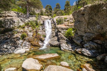 Water cascades over the Cascade des Anglais on the L'Agnone river through the forest and mountains of the GR20 trail at Vizzavona on the Mediterranean island of Corsica