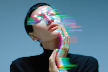 Fototapeta premium Model experiencing digital distortion glitch effect, touching face with hands