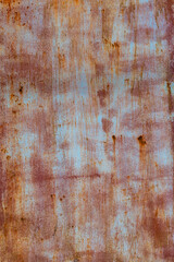 Weathered sheet metal surface with rust texture in industrial setting