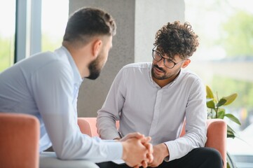 Psychologist listening to patient talking about problems during therapy session