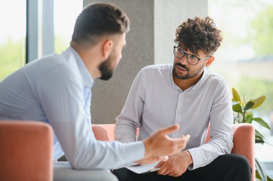 Psychologist listening to patient talking about problems during therapy session