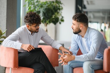 Psychotherapist listening to patient talking about problems during therapy session