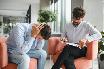 Psychologist listening to patient talking about problems during therapy session