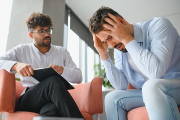 Psychologist listening to patient talking about problems during therapy session