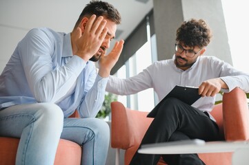 Psychologist comforting desperate patient during therapy session