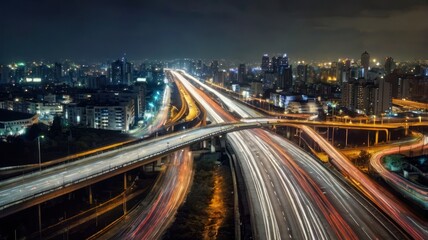 Obraz premium City highway intersection at night. Lights streak across
