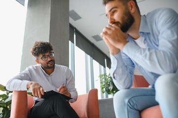 Psychologist listening to patient talking about problems during therapy session