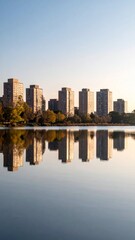 Fototapeta premium Serene Urban Reflection Apartment Buildings Lakeside Sunset.