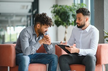 Psychologist listening to patient talking about problems during therapy session