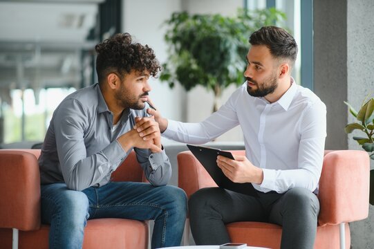 Psychologist comforting patient during therapy session