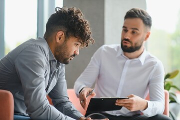Psychologist supporting upset arab man during therapy session