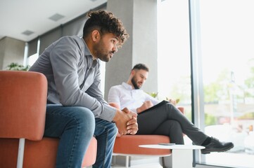 Upset arab man suffering from ptsd visiting psychologist for therapy session
