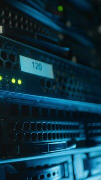 Vertical shot of indicators and number labels on server equipment in data center, no people