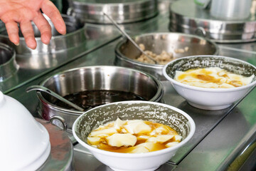 A delicious bowl of soft tofu pudding, known as 