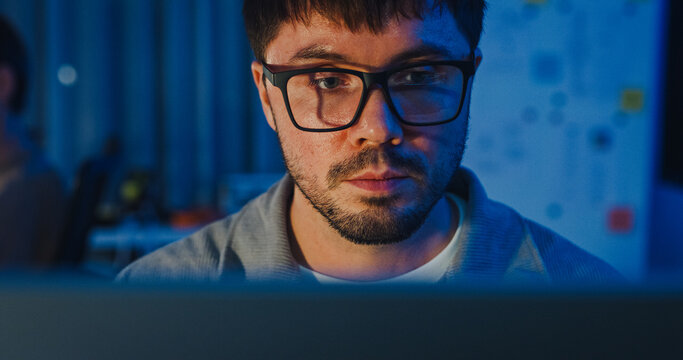 Closeup team adult male freelance work late typing write prompt AI bot app program nomad terminal code at office night. Artificial intelligence dashboard, robotics, user interface, machine learning.