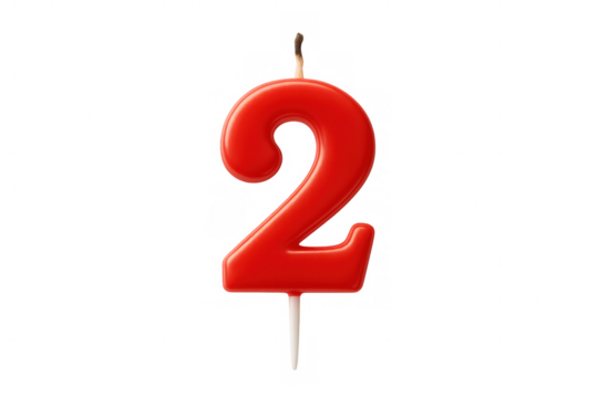 Red wax number 2 birthday candle burning out, lying on clear background, symbolizing second year milestone for party decoration