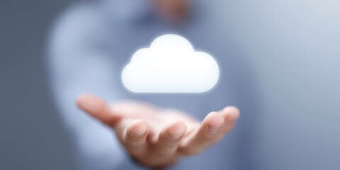 Hand of a person presenting a glowing cloud symbol, representing cloud computing technology, with a blurred background emphasizing digital innovation and connectivity