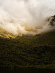 Green hills meet Lough Callee and the sky, covered in clouds, gives it a magical feel in Ireland.