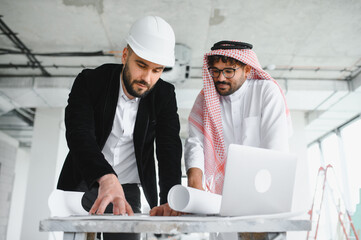 Architect and investor discussing real estate construction project